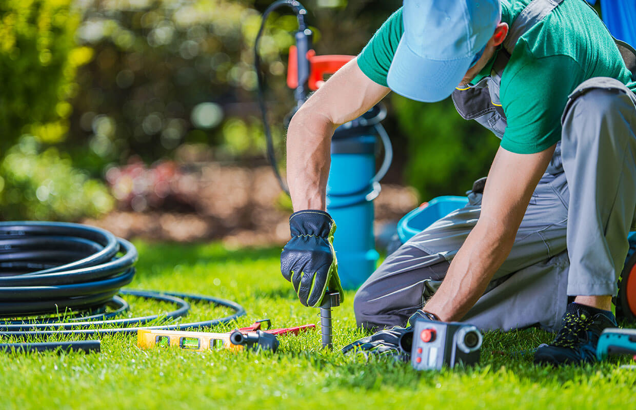 Gardener places soil testing equipment into the soil