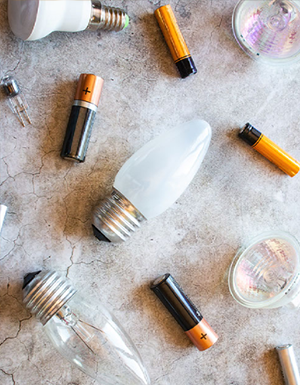 Batteries and lightbulbs on a neutral background
